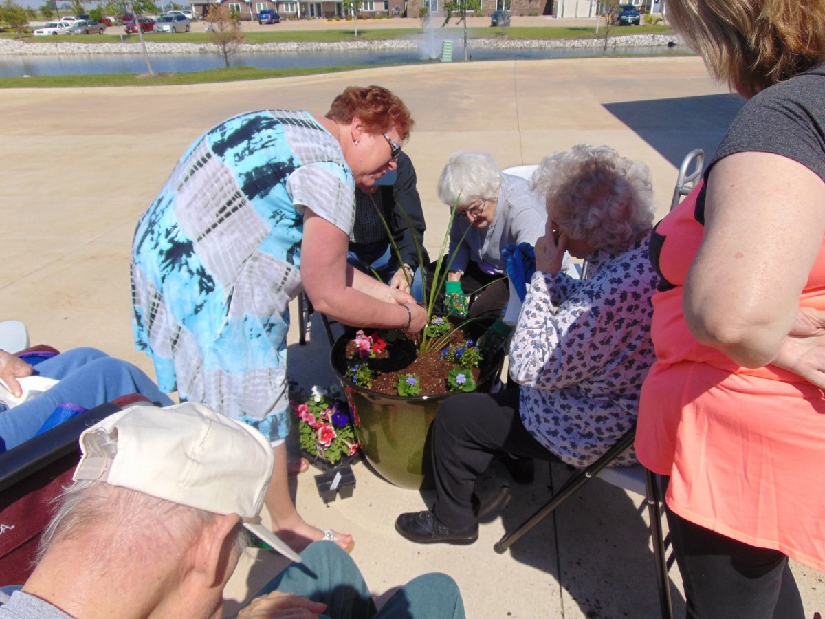 A group of people gathered outdoors, engaged in conversation.