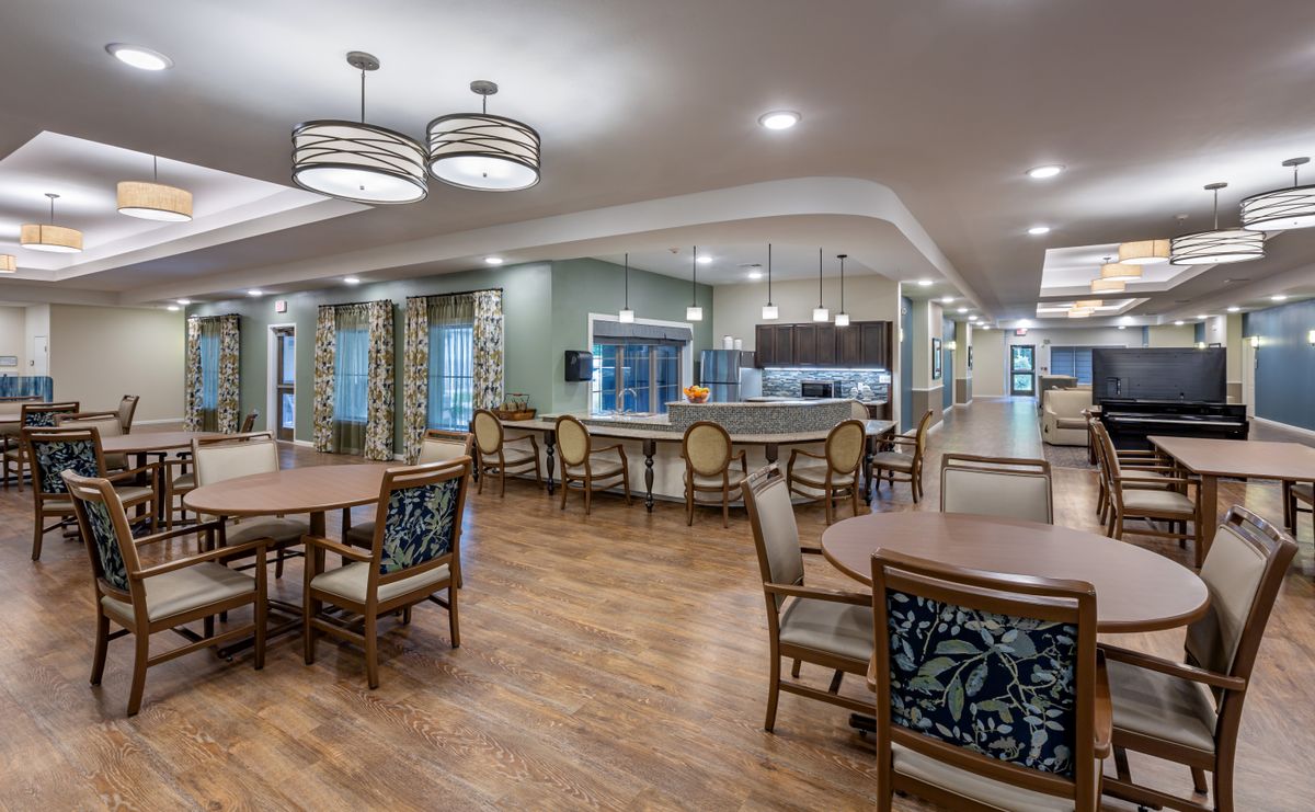 A spacious dining area with modern lighting and hardwood flooring.