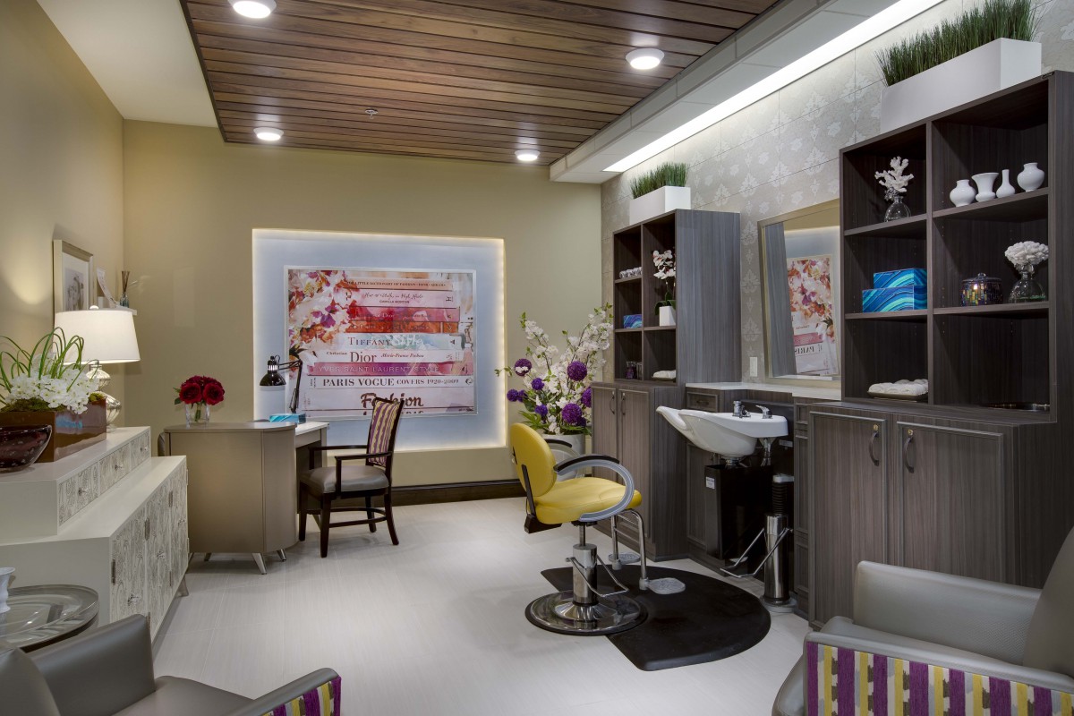 A modern and luxurious salon interior featuring a hair styling station and elegant furnishings.