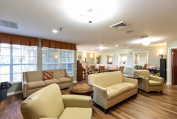 A spacious and modern living room with comfortable sofas and a bright atmosphere.