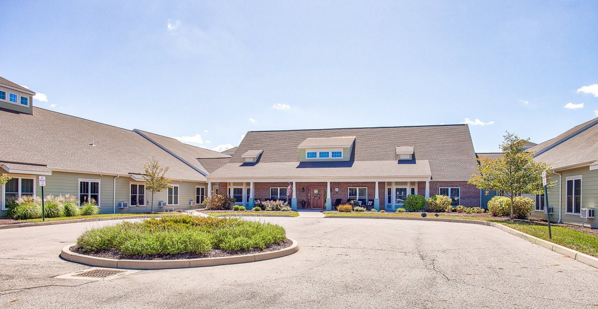 A residential-style building with a well-maintained driveway and landscaped surroundings.