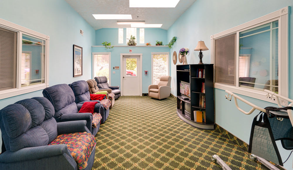 A cozy living room with comfortable seating and a bookshelf.