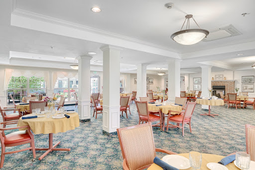 A spacious and well-lit dining area featuring comfortable seating and elegant decor.
