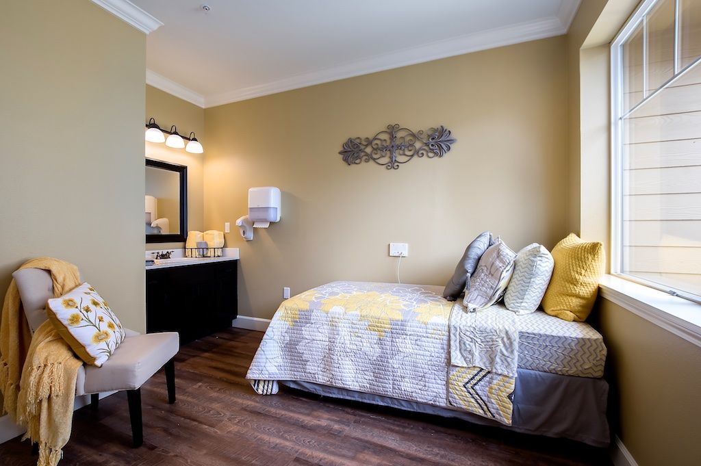 A modern bedroom interior with a cozy bed and yellow accents.