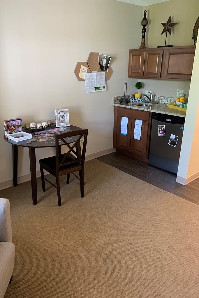 A small, cozy kitchen in an apartment with a table and chair setup.