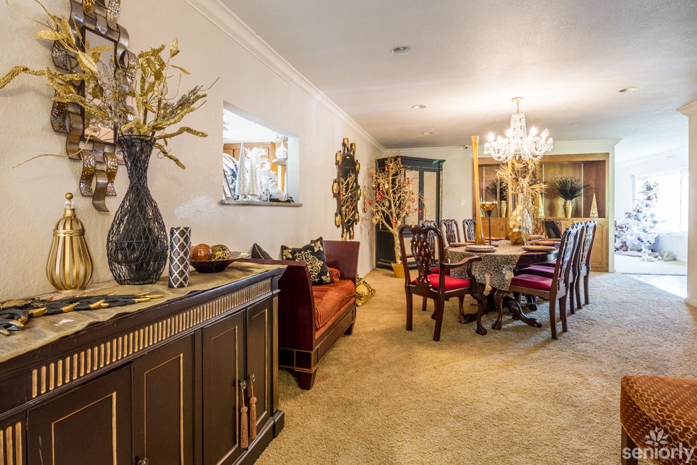 A cozy dining room with elegant decor and a chandelier.