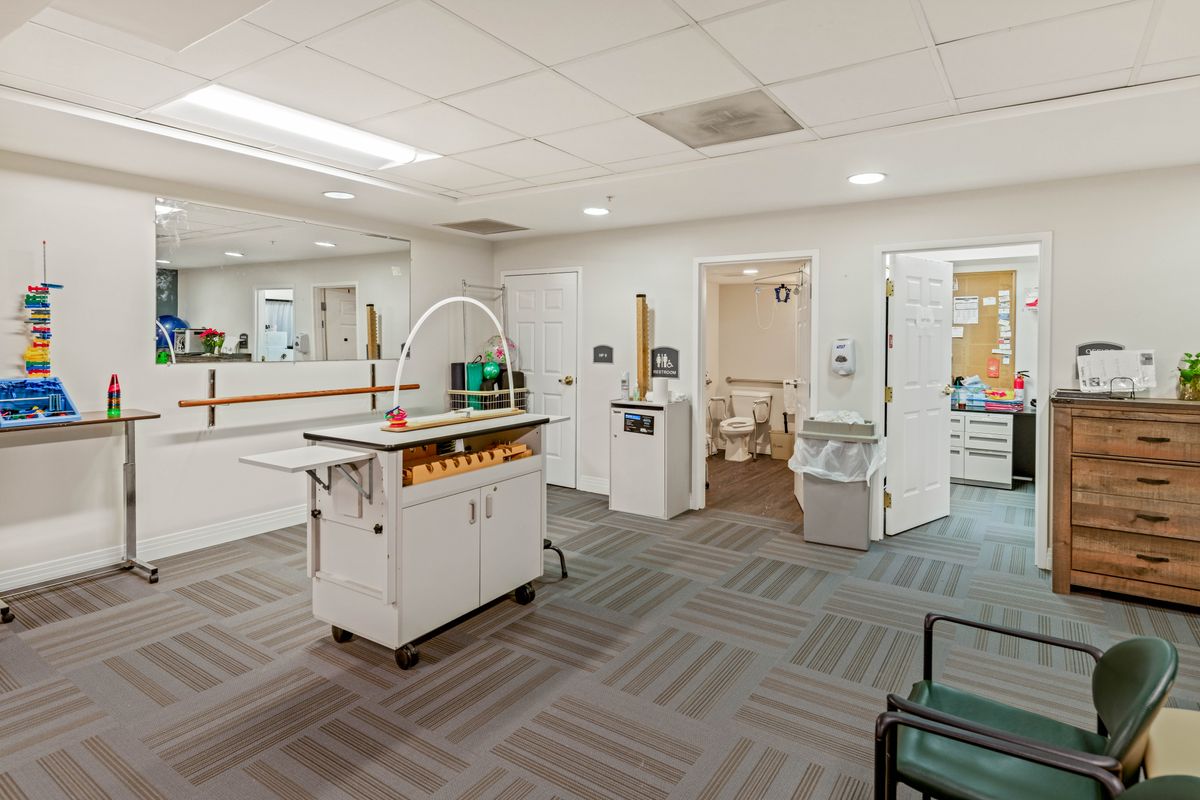 A modern office space with organized furniture and bright lighting.