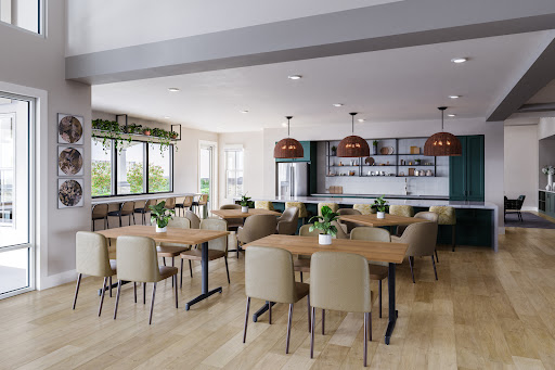 A modern dining area featuring sleek furniture, warm lighting, and plenty of greenery.