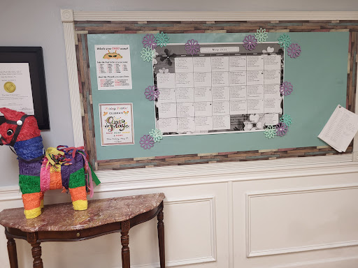 A vibrant classroom bulletin board with a list of activities and colorful decorations, complemented by a small table in the foreground.
