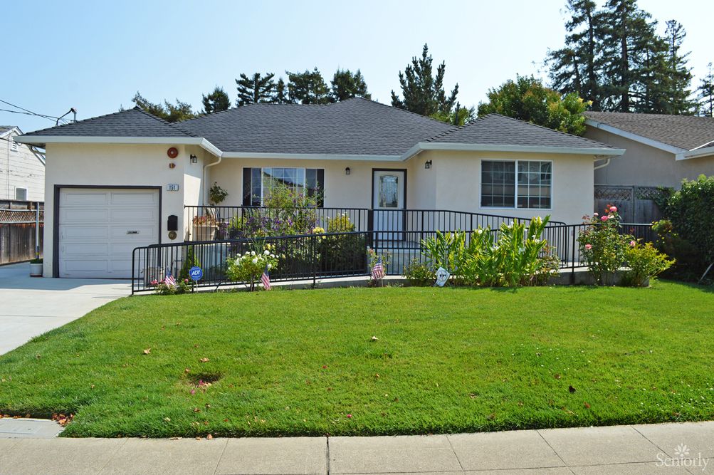 A single-story house with a well-maintained front yard and garden.