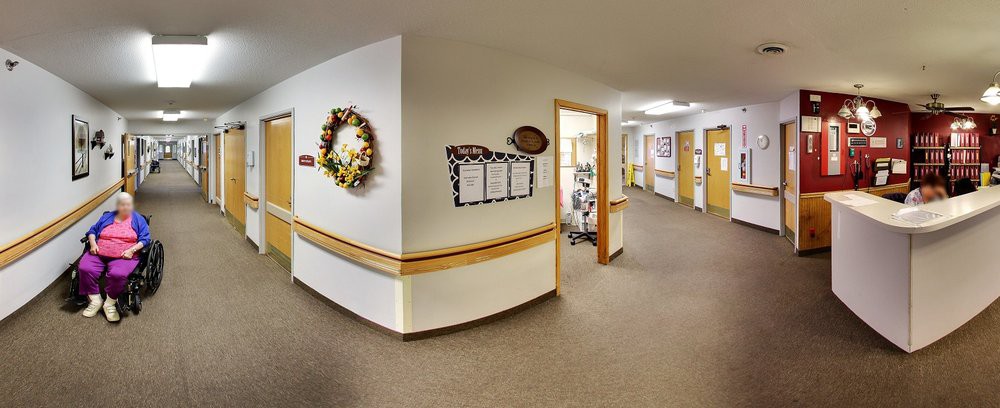 A decorated hallway in an office setting, featuring a wreath and notice board.