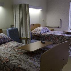 A hospital room featuring two beds, designed for patient comfort and care.