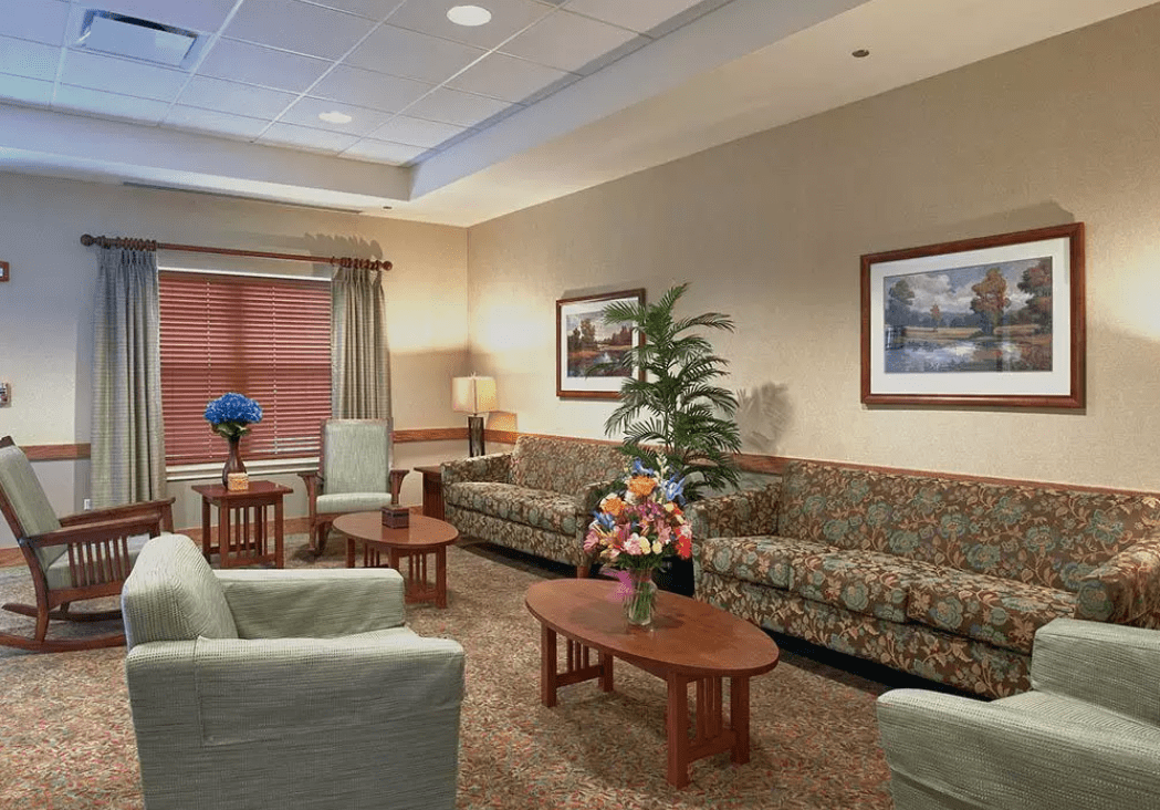 A comfortable waiting room with sofas, chairs, and decorative elements.