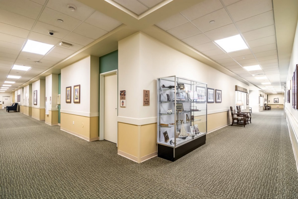 A well-lit hallway with a museum display showcasing various artifacts.