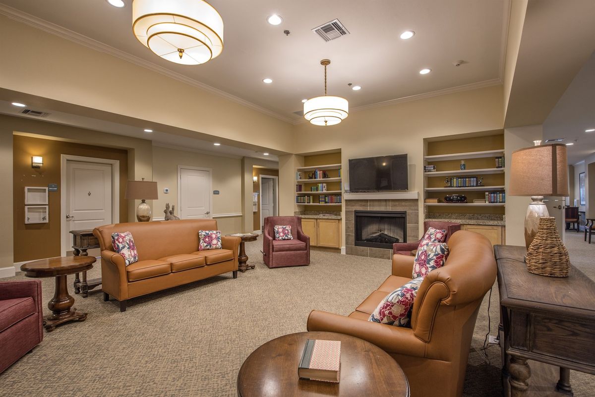 A cozy living room with comfortable seating and warm lighting.