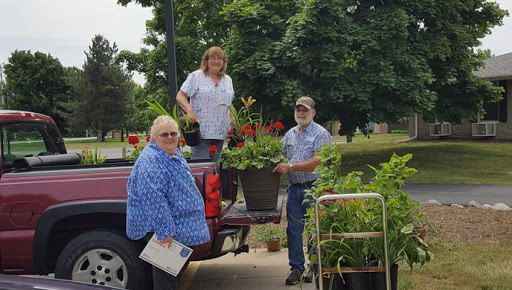 Volunteers work together to plant flowers and beautify the community.