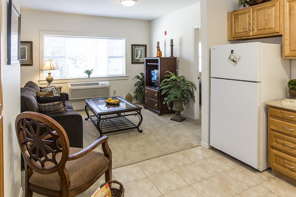 A cozy living room and kitchen area with modern furniture and decor.