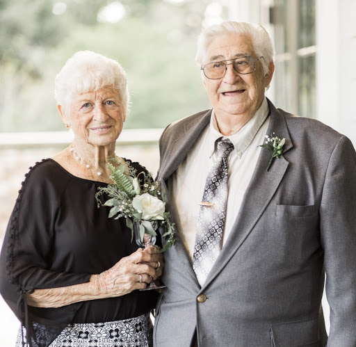A joyful elderly couple celebrating their love on a special day.