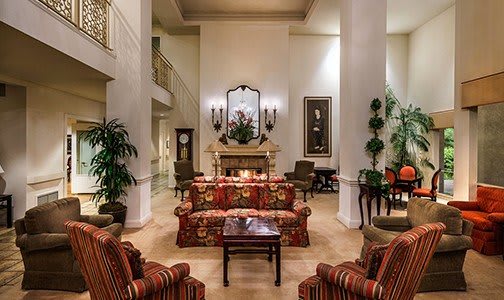 Elegant hotel lobby with luxurious furniture and decor.