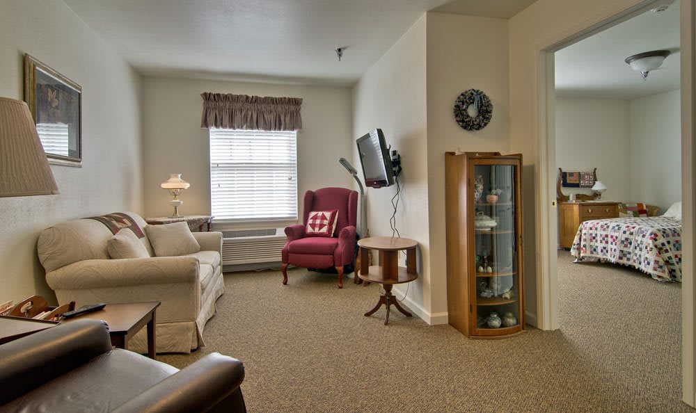 A cozy living room with comfortable seating and a wall-mounted television.