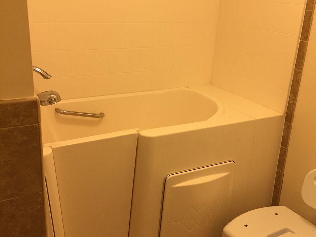 A bathroom featuring a walk-in bathtub designed for accessibility.