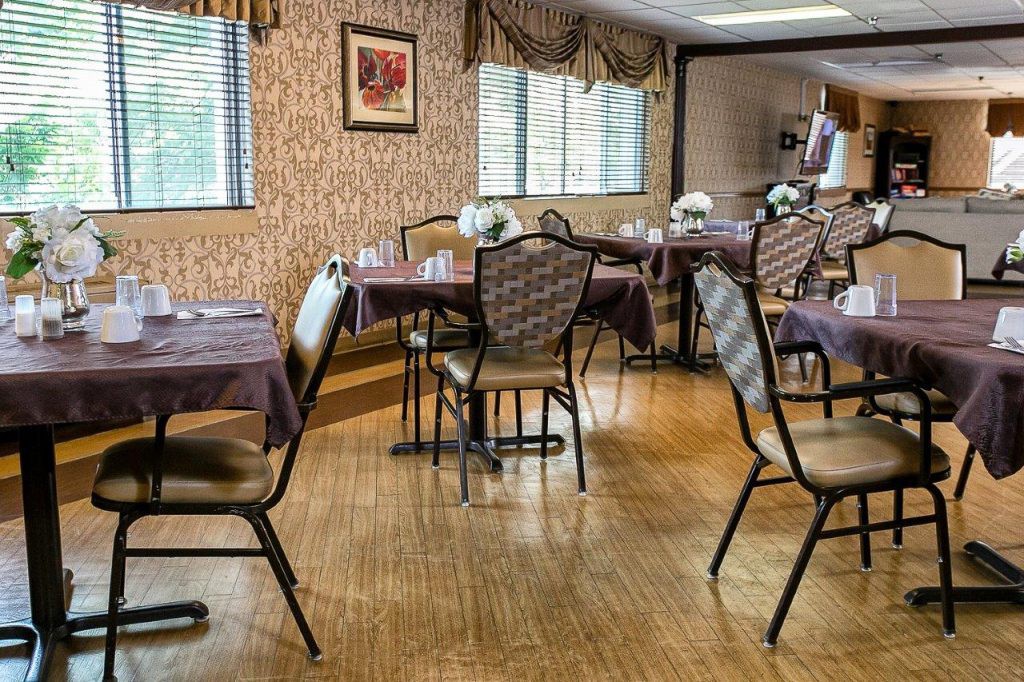 An empty dining room with decorated tables and chairs.