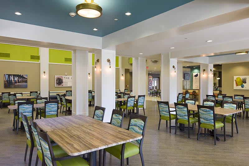 A modern dining area with vibrant decor and well-arranged tables and chairs.