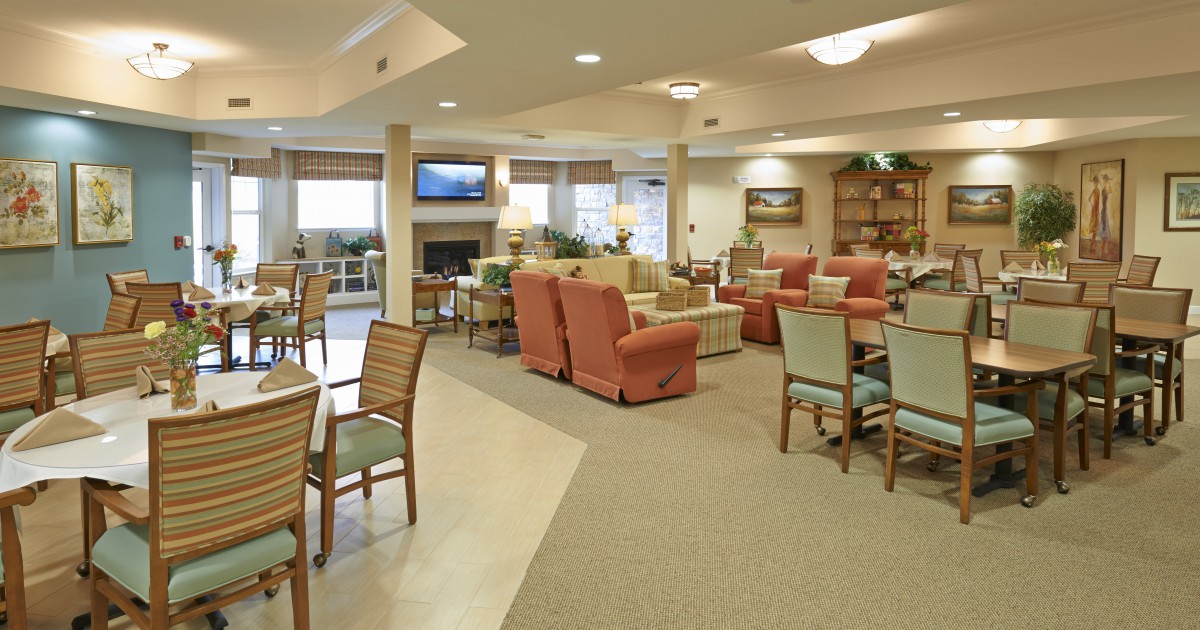 A spacious and comfortable lounge area with various seating options and warm decor.