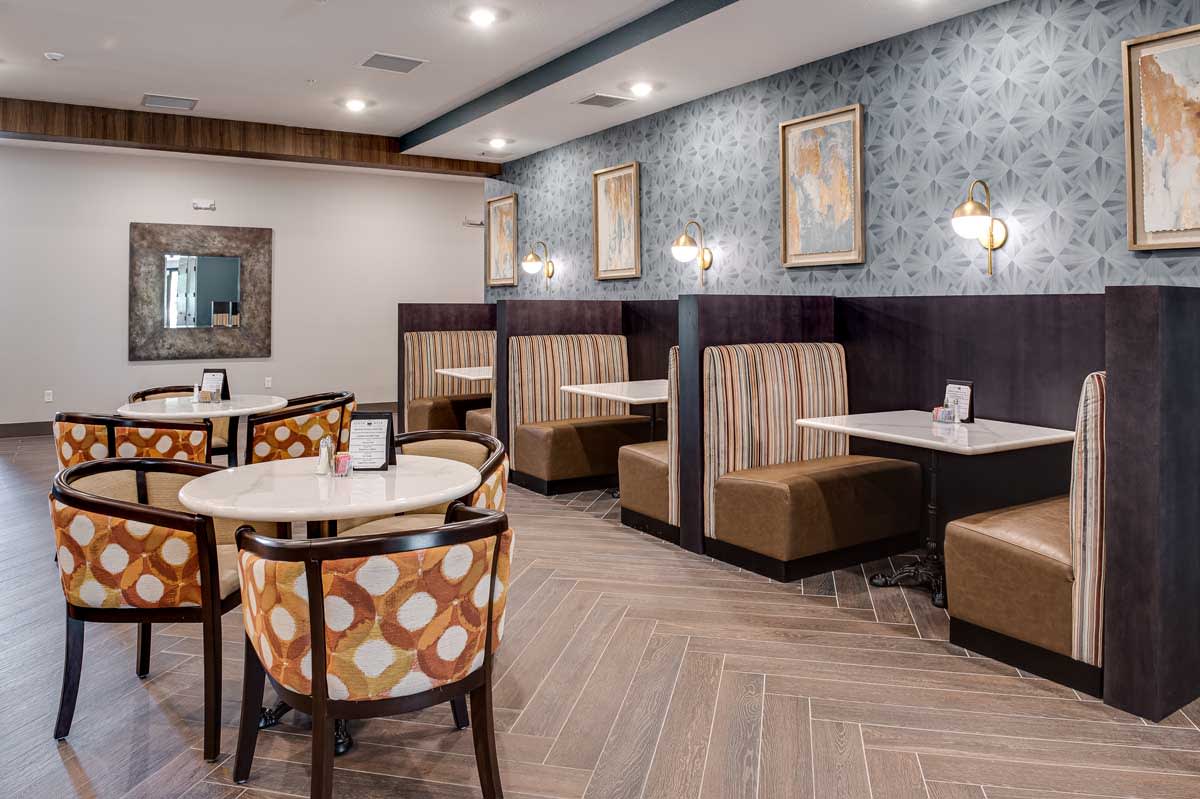 A cozy restaurant interior with booth seating and elegant decor.