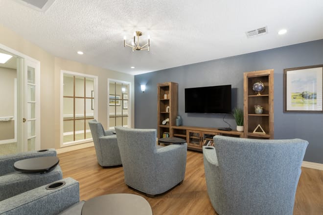 A modern living room with comfortable seating and a wall-mounted television.