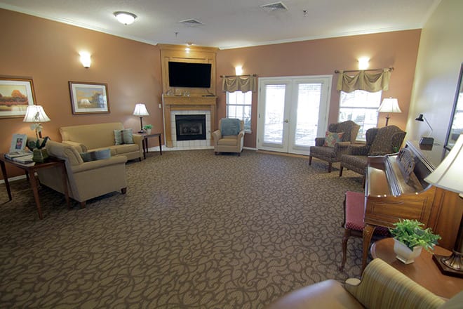 A cozy living room with multiple seating options, a fireplace, and a television.