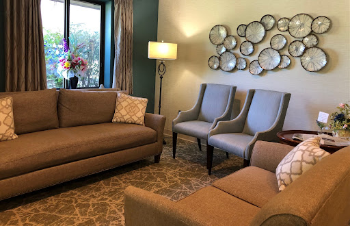 A cozy living room featuring a comfortable sofa, stylish armchairs, and decorative wall art.