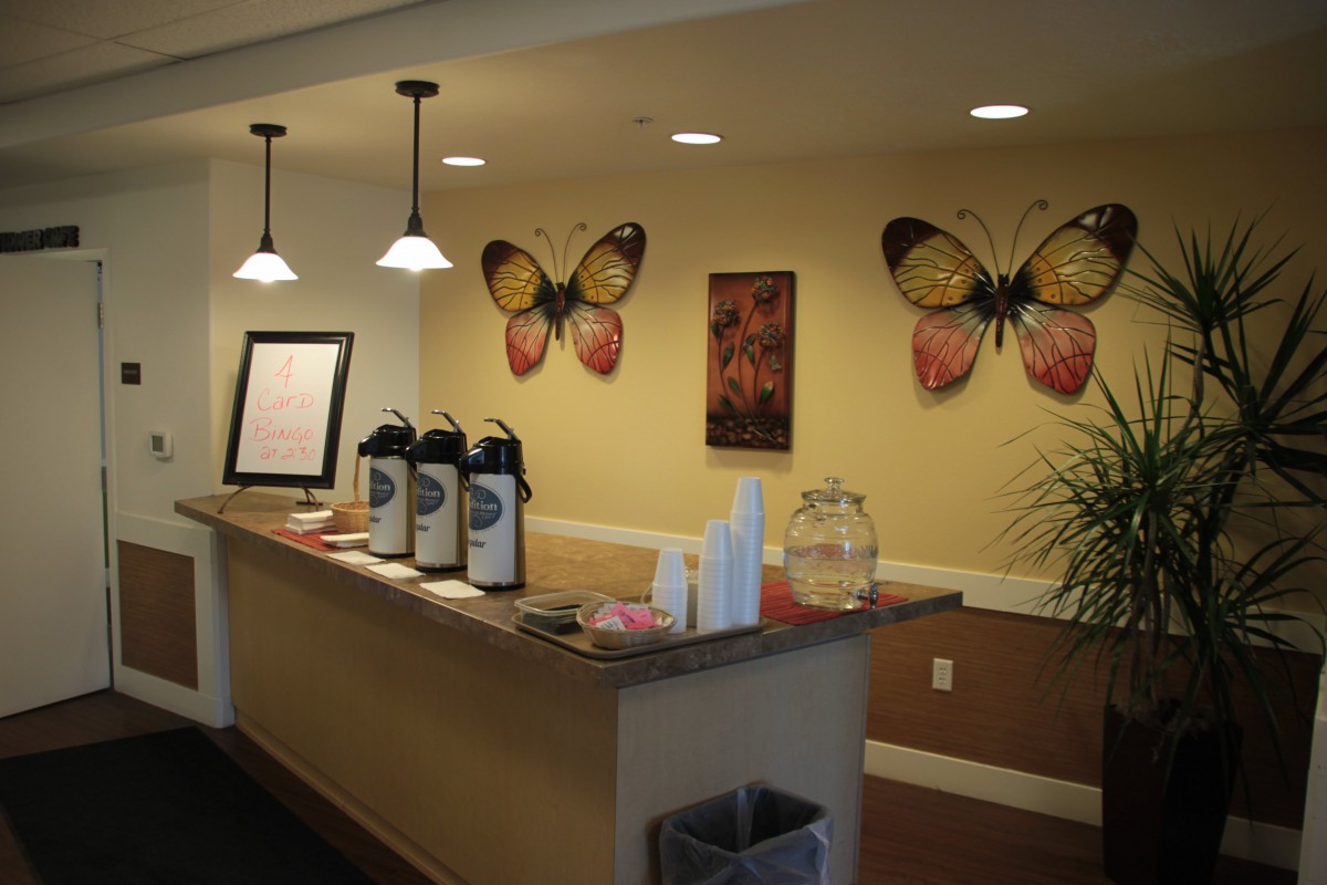 A welcoming reception area with a coffee station and butterfly wall decorations.