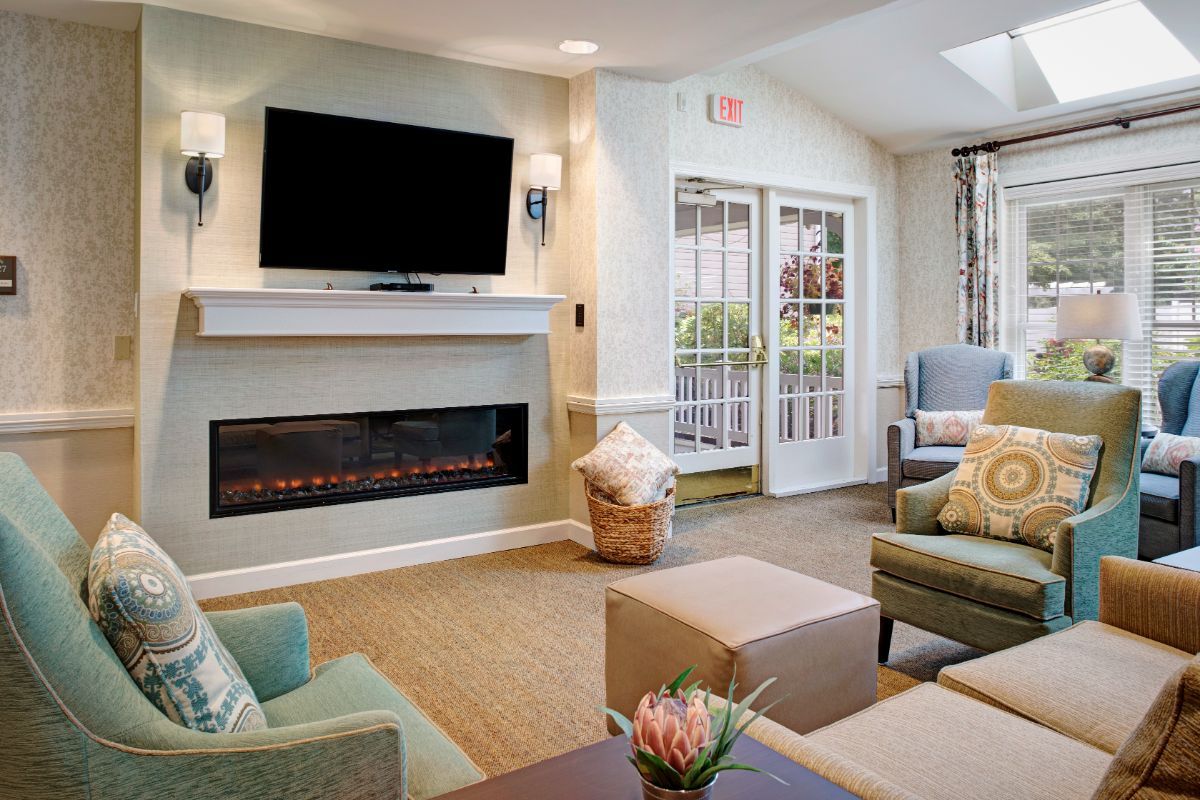 A cozy living room with modern decor, featuring a fireplace and television.