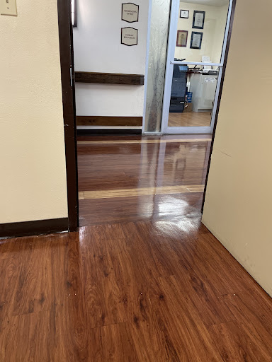 A view through a doorway showcasing polished wooden flooring in an indoor space.