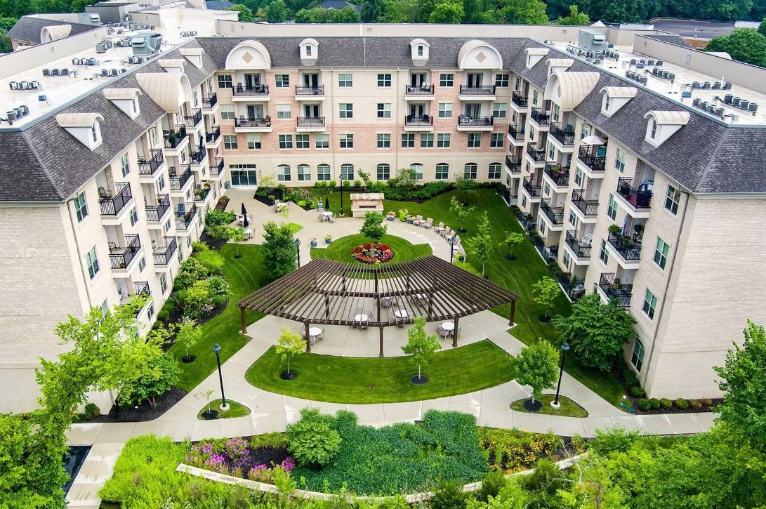 Aerial view of a residential building with a landscaped courtyard.