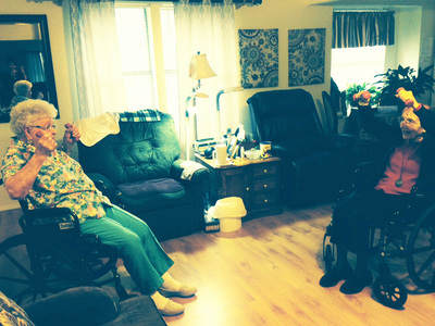 A cozy living room scene with people relaxing on the sofas.