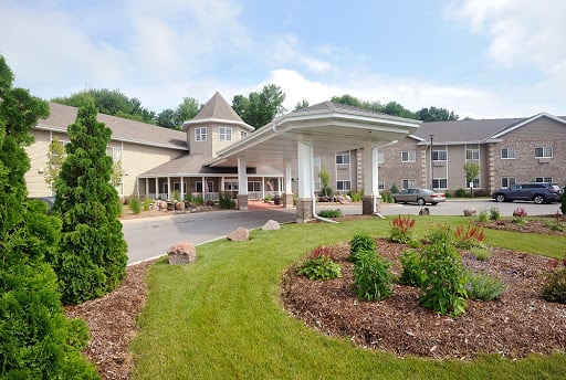 Exterior view of a hotel with landscaped gardens and a prominent entrance.