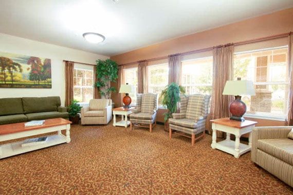 A cozy and well-lit living room featuring comfortable seating and tasteful decor.