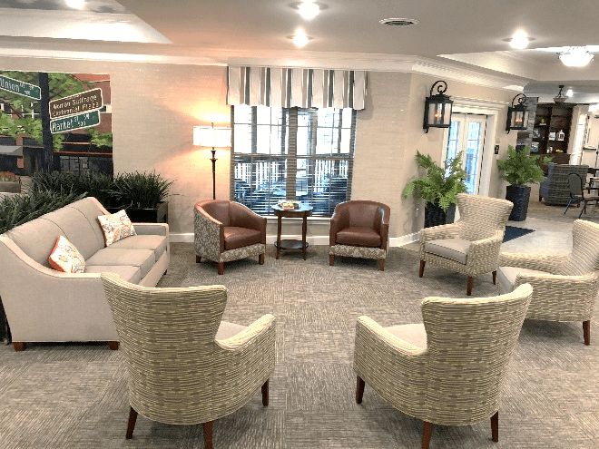 A cozy living room with arranged seating and warm lighting.