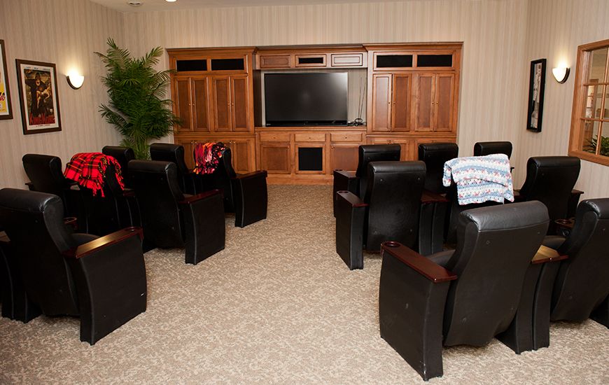 A cozy home theater setup with comfortable seating and a large screen.