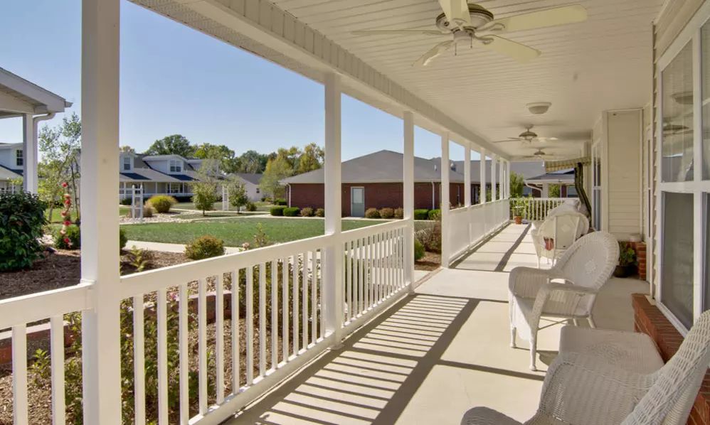 A spacious porch overlooking a well-maintained suburban neighborhood.