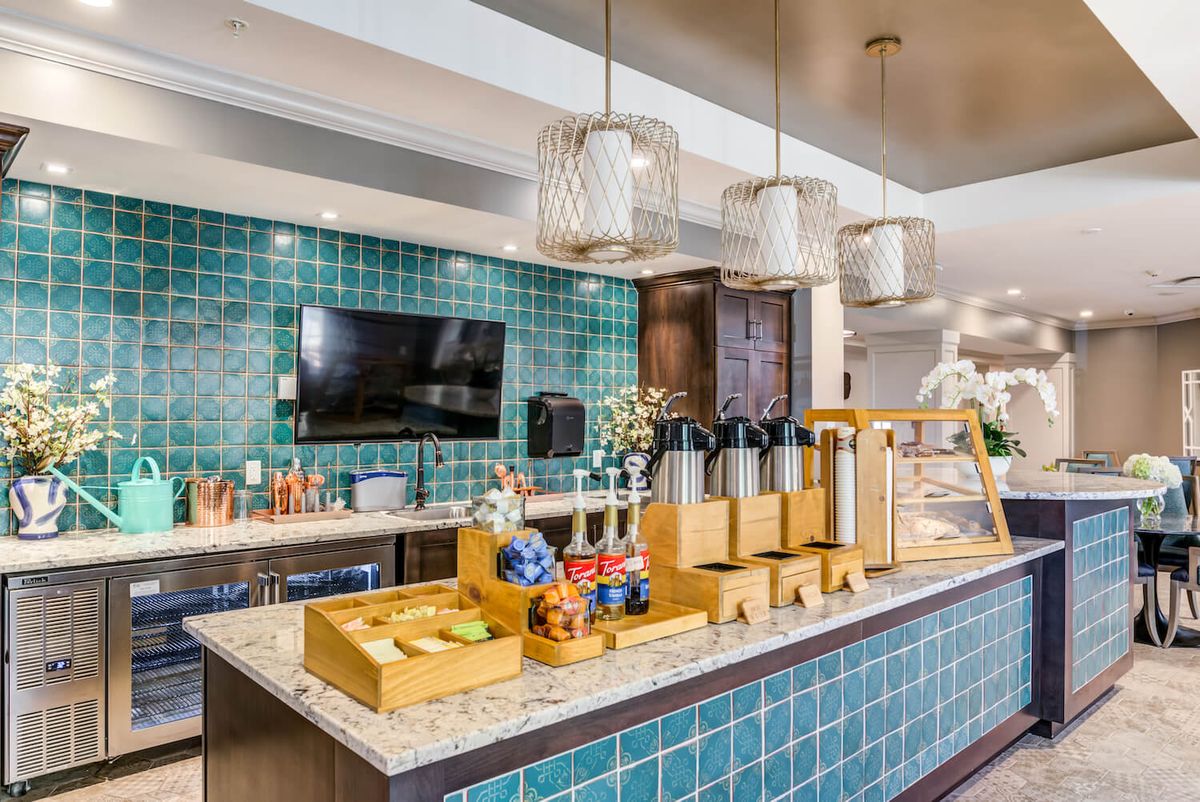 A modern cafe interior with a coffee station and stylish decor.