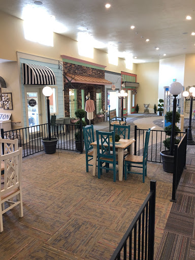 An inviting indoor shopping area featuring colorful seating and decorative elements.