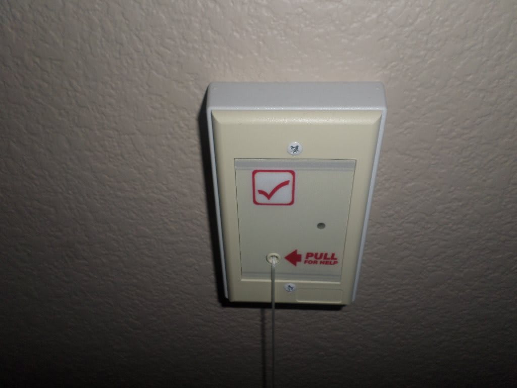 A wall-mounted emergency call button.