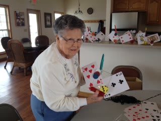 A person holding playing cards indoors.