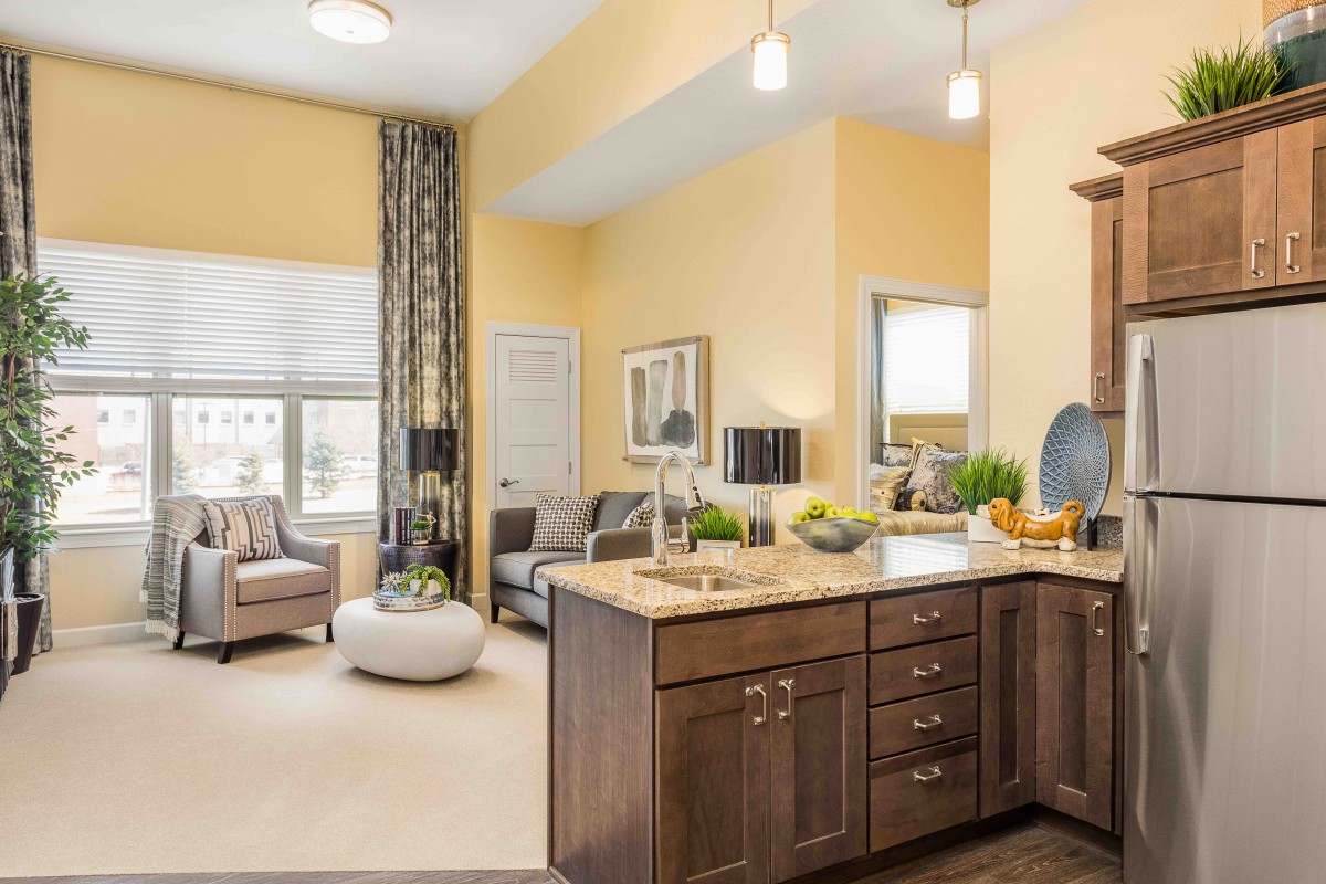 A modern open-concept living space with a kitchen and seating area.