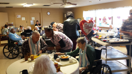 A vibrant gathering at a care center where residents enjoy meals and socialize together.
