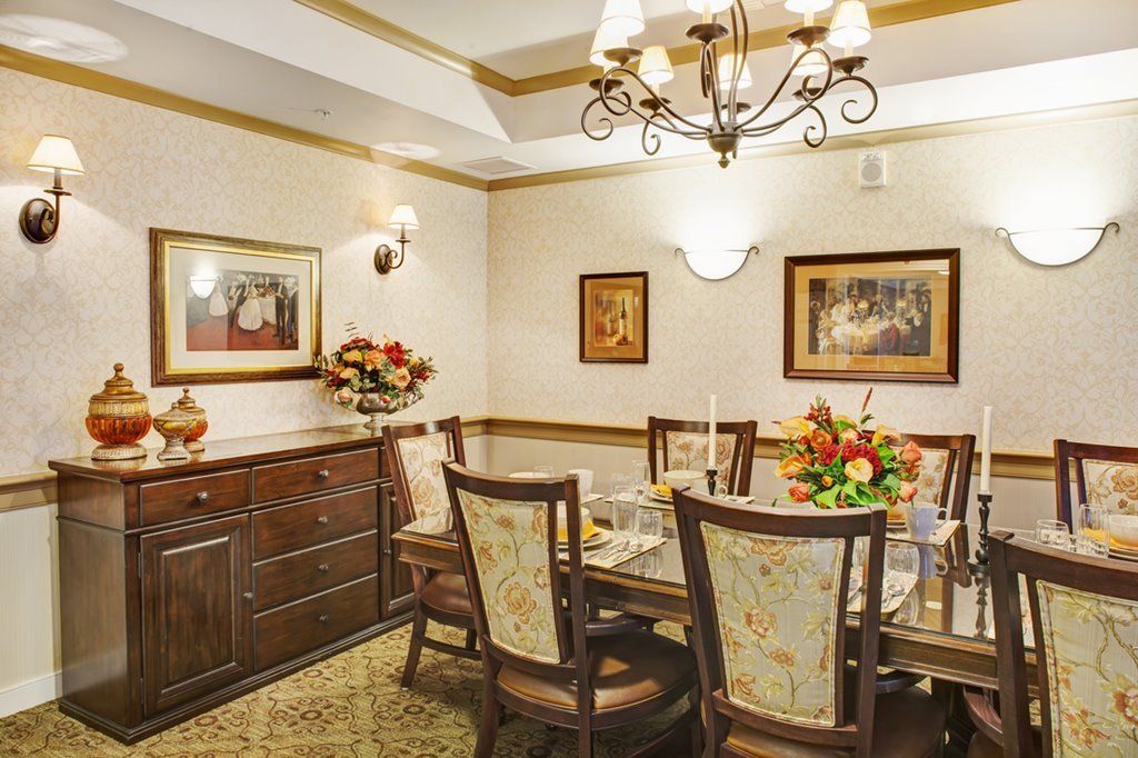 A traditionally styled dining room with a chandelier and elegant table setting.