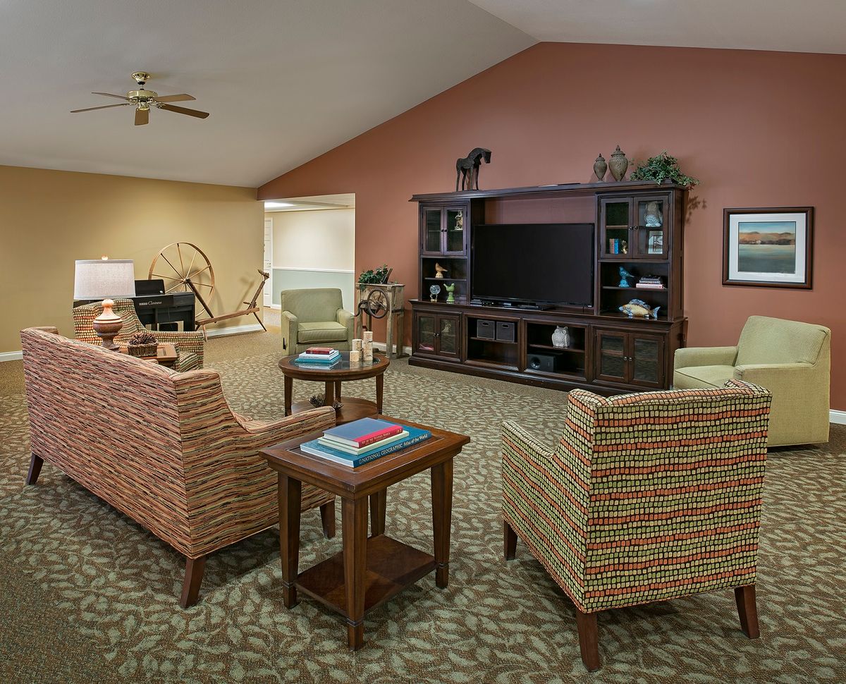 A cozy living room with comfortable seating and an entertainment center.